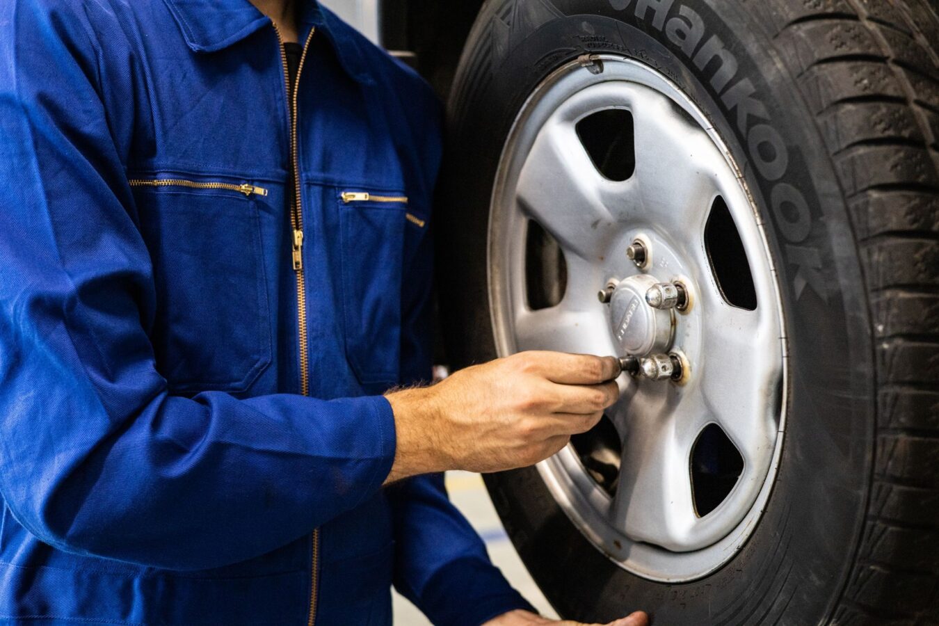 mechanic inspecting runflat tire sidewall for cracks and bulges