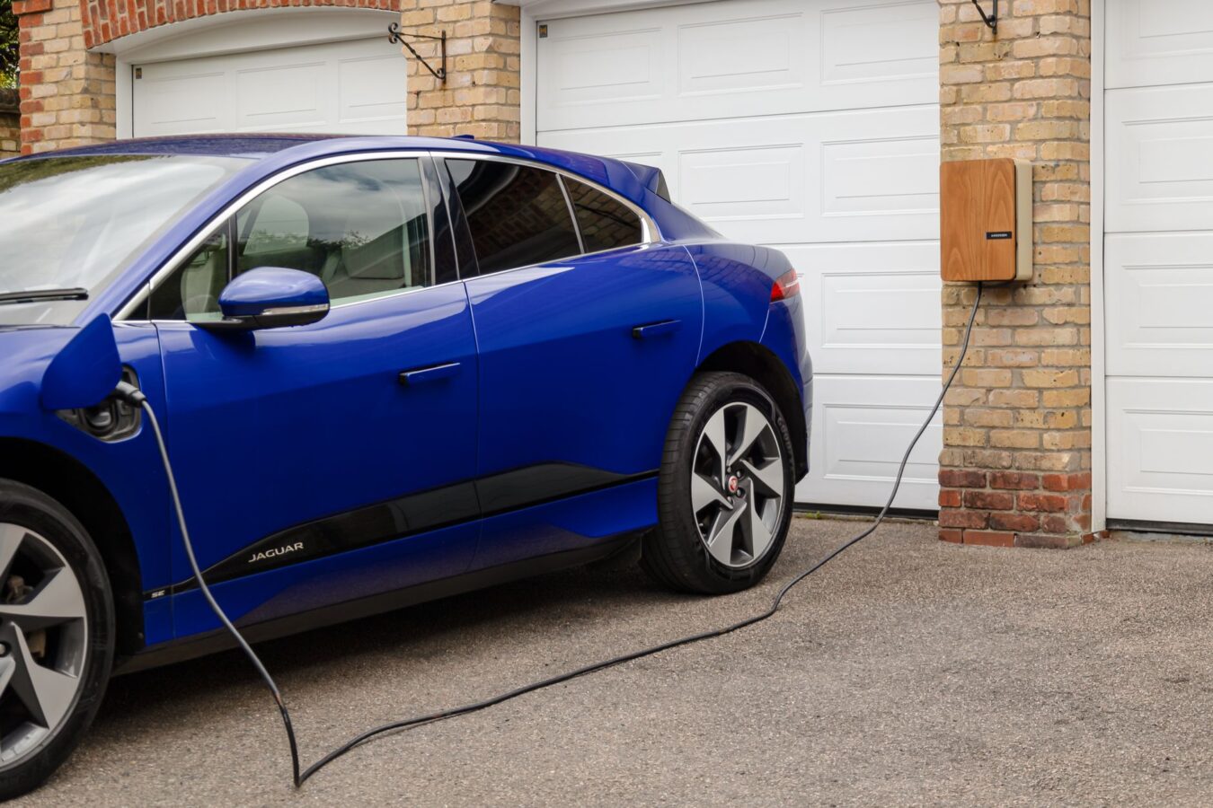 electrician installing home ev charger in residential garage