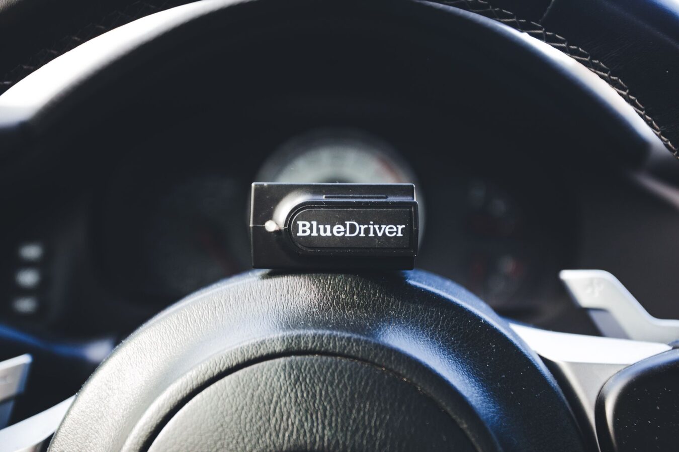 adaptive cruise control radar sensor behind car grille close-up