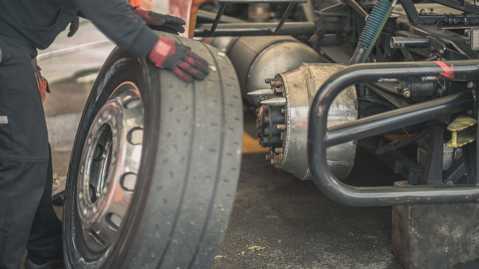mechanic replacing fog light bulb on car bumper