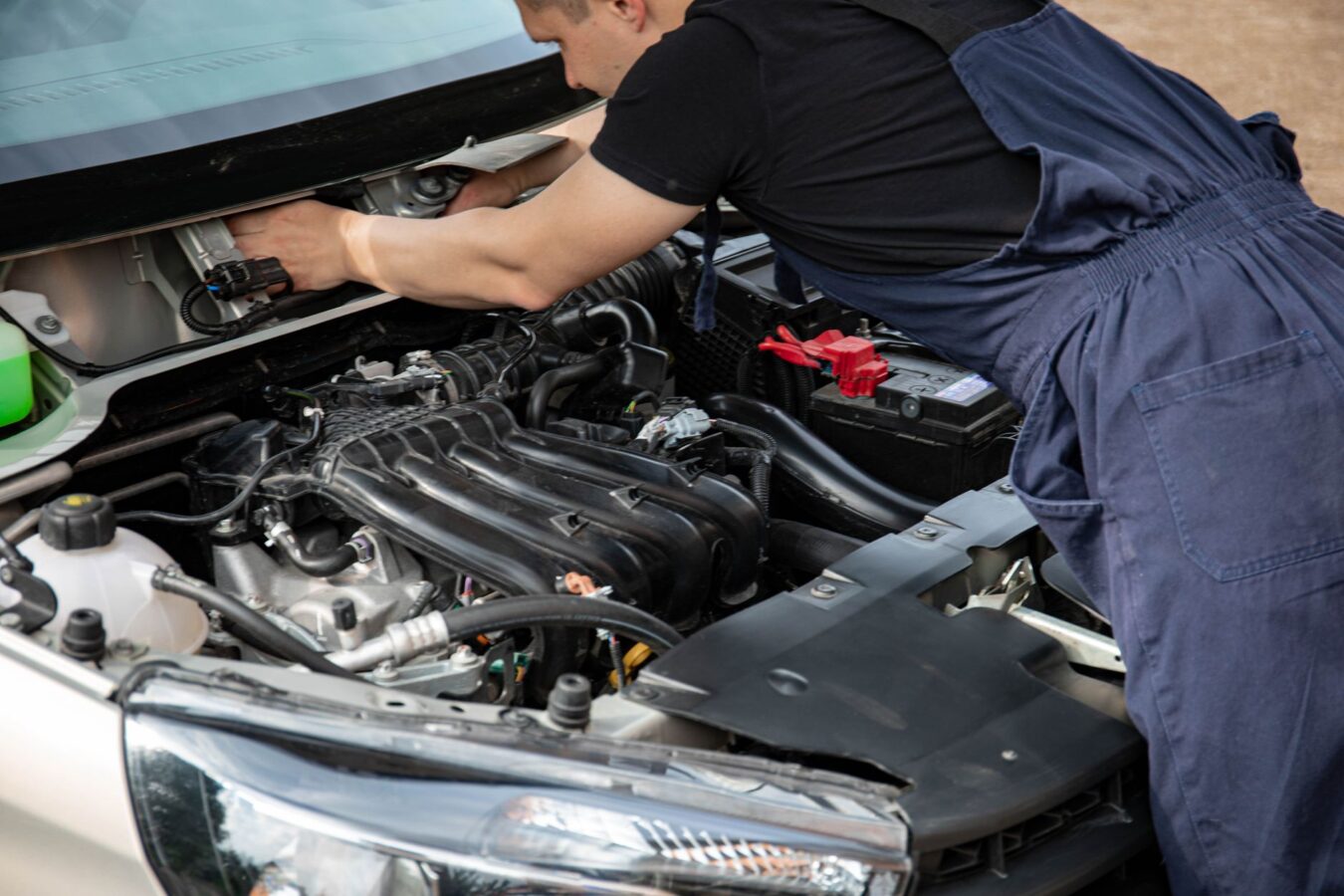 mechanic replacing car headlight module workshop repair