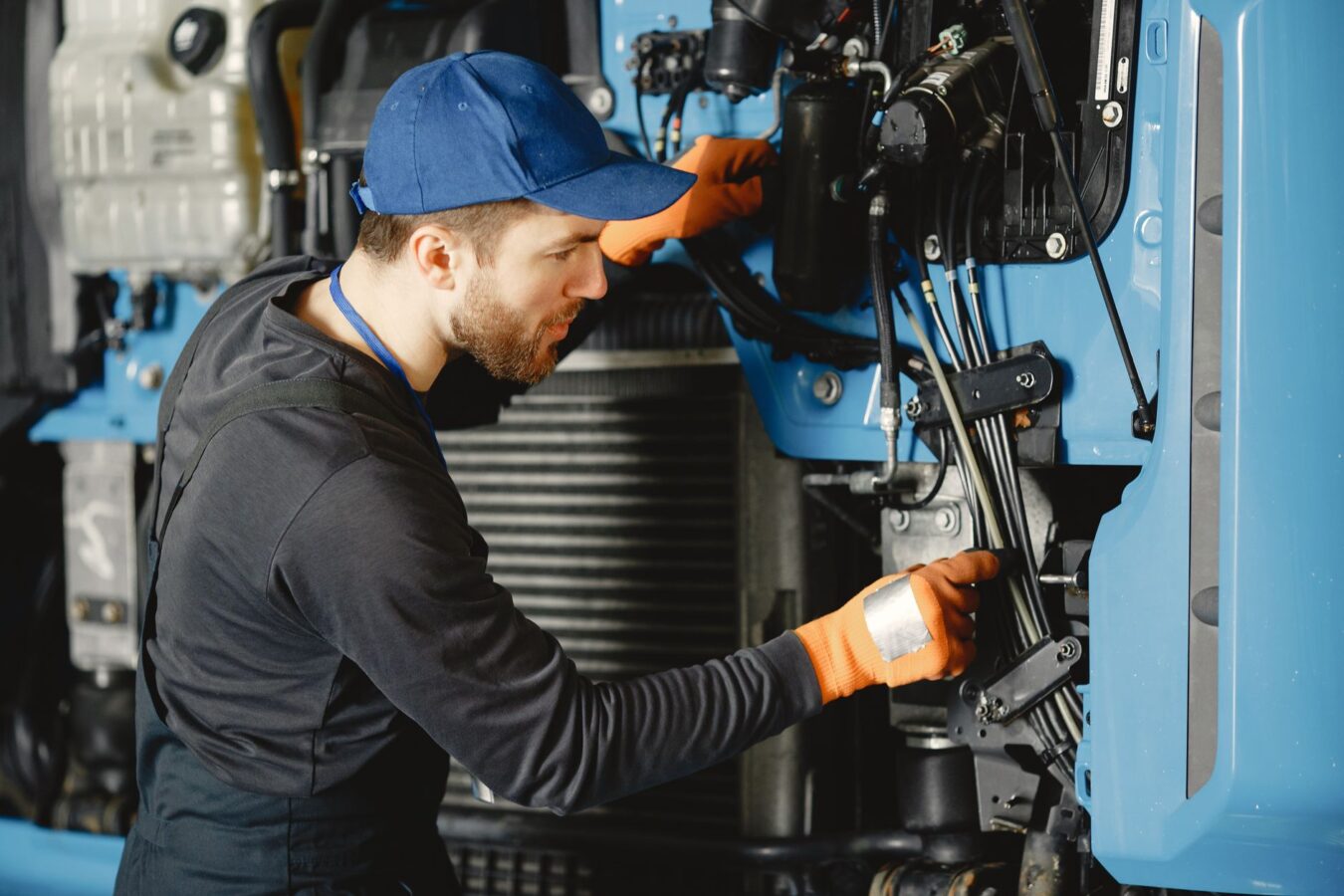 mechanic adjusting gear linkage
