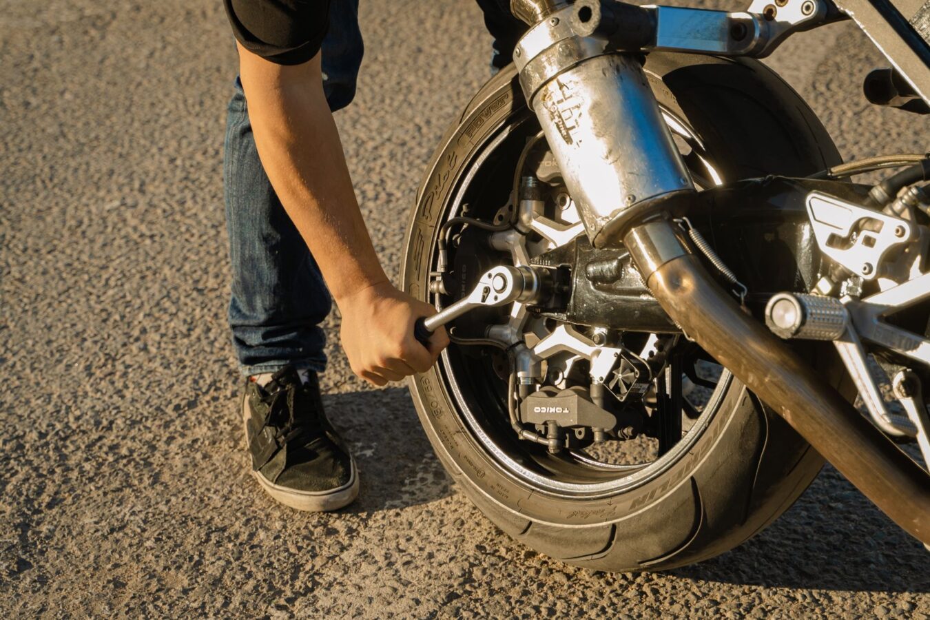 mechanic installing new wheel arch liner with proper torque wrench