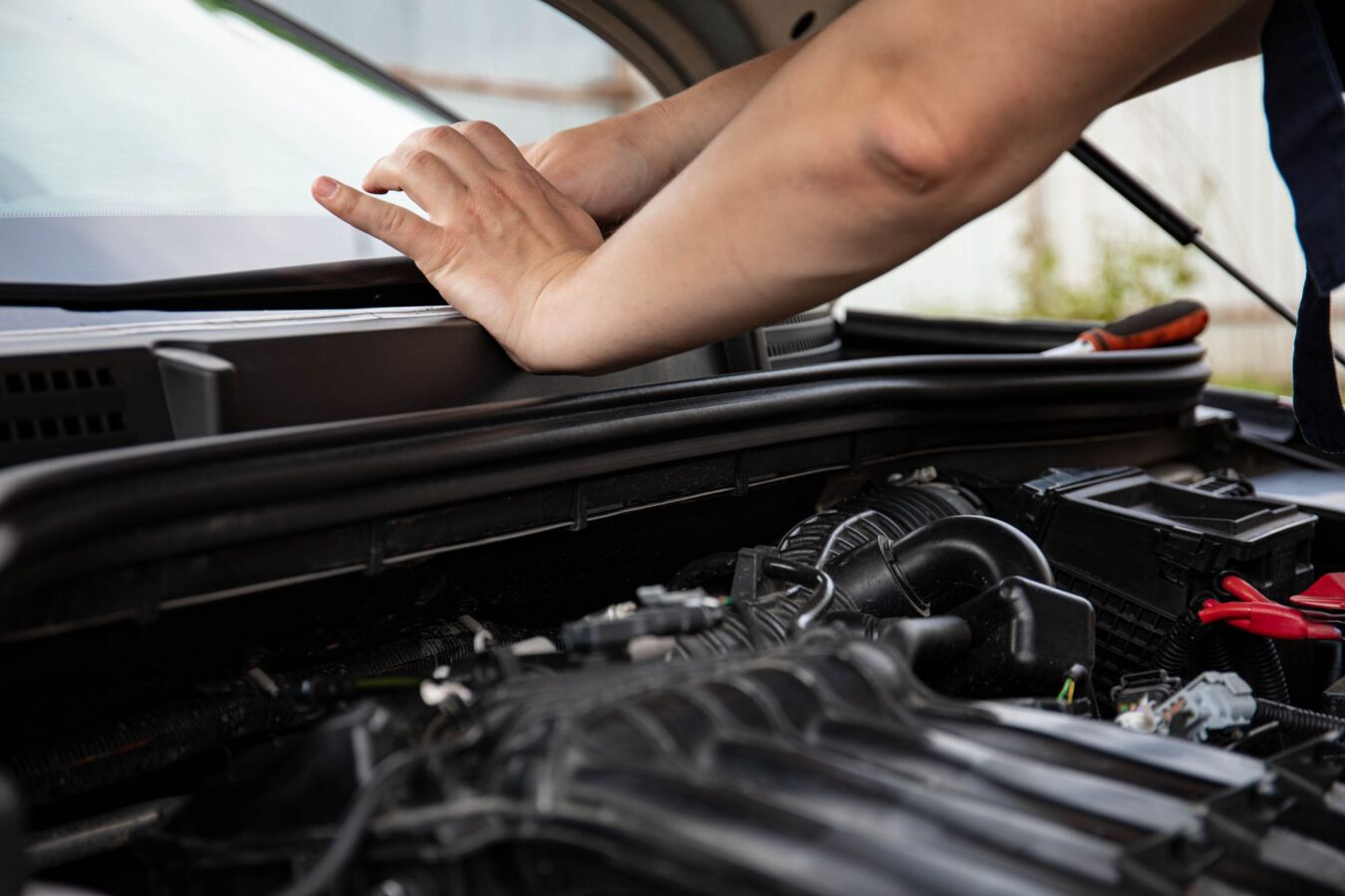 mechanic replacing hood liner insulation