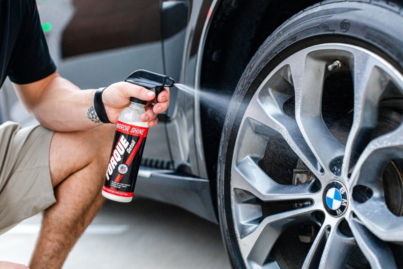 mechanic cleaning throttle body with spray cleaner