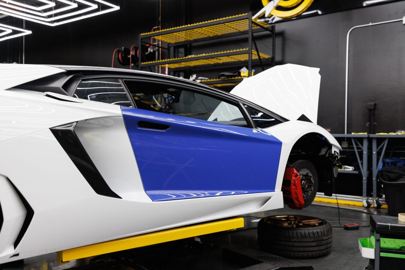 mechanic measuring car frame alignment with laser system