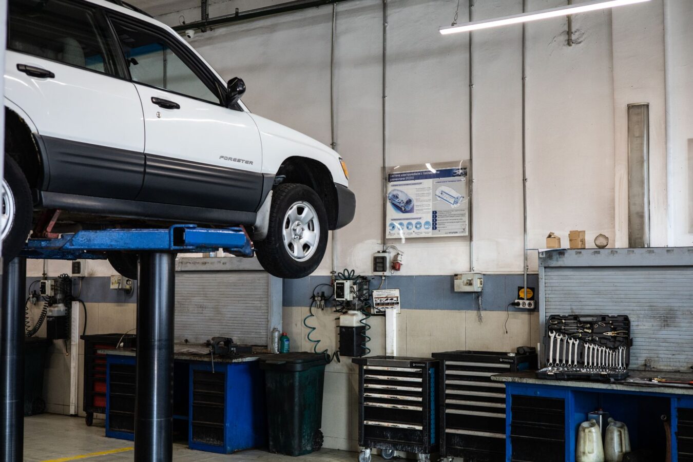 Car on hydraulic lift during tire rotation service