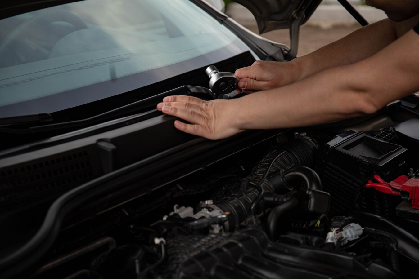 mechanic hands adjusting turbocharger wastegate arm and actuator rod