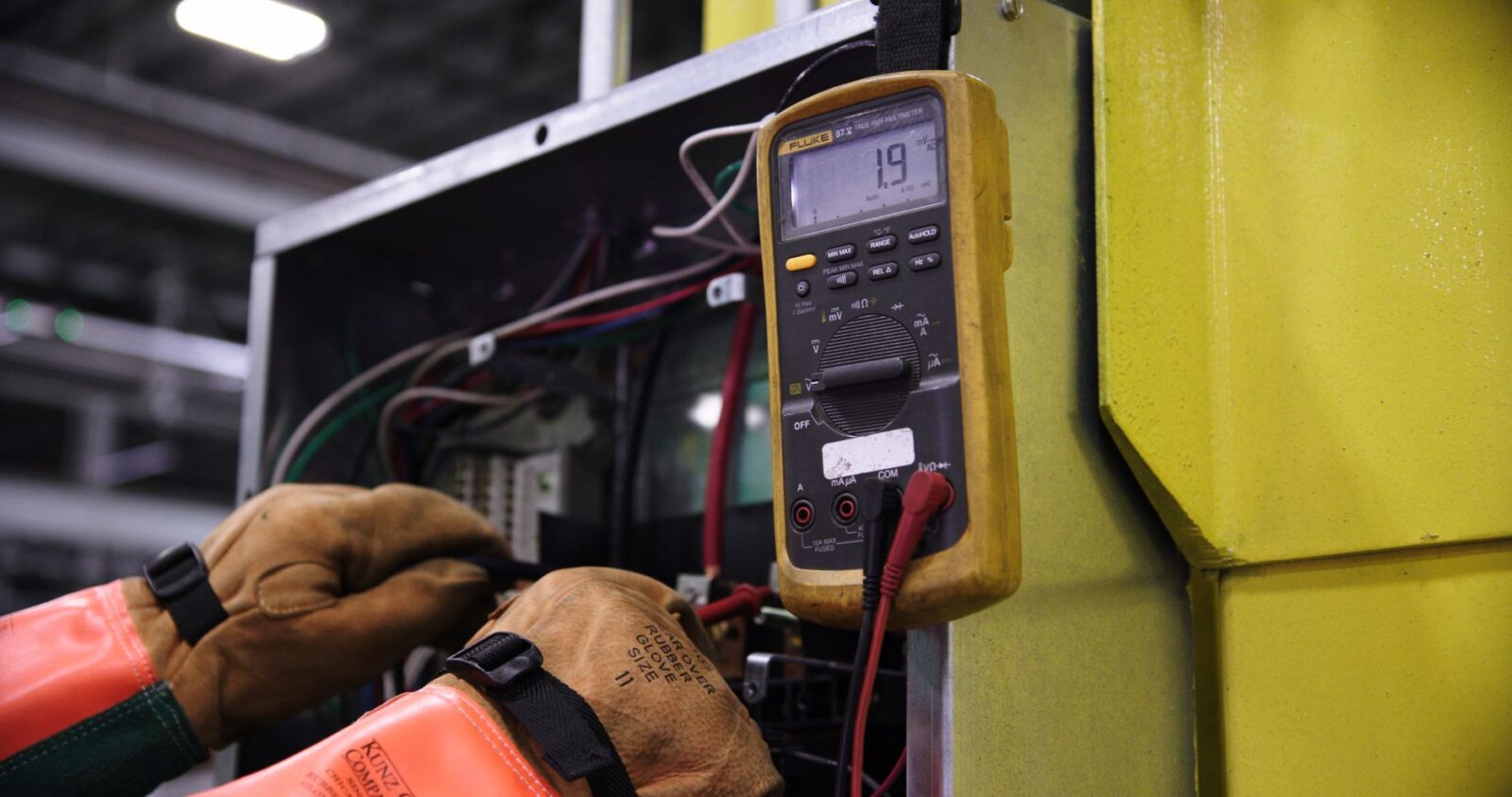 mechanic testing parking sensor with multimeter