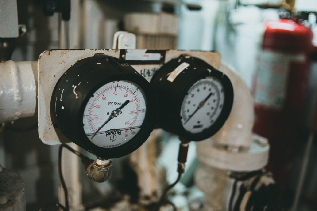 mechanic testing fuel pressure with gauge