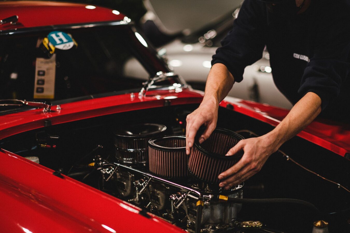 mechanic installing spin-on oil filter