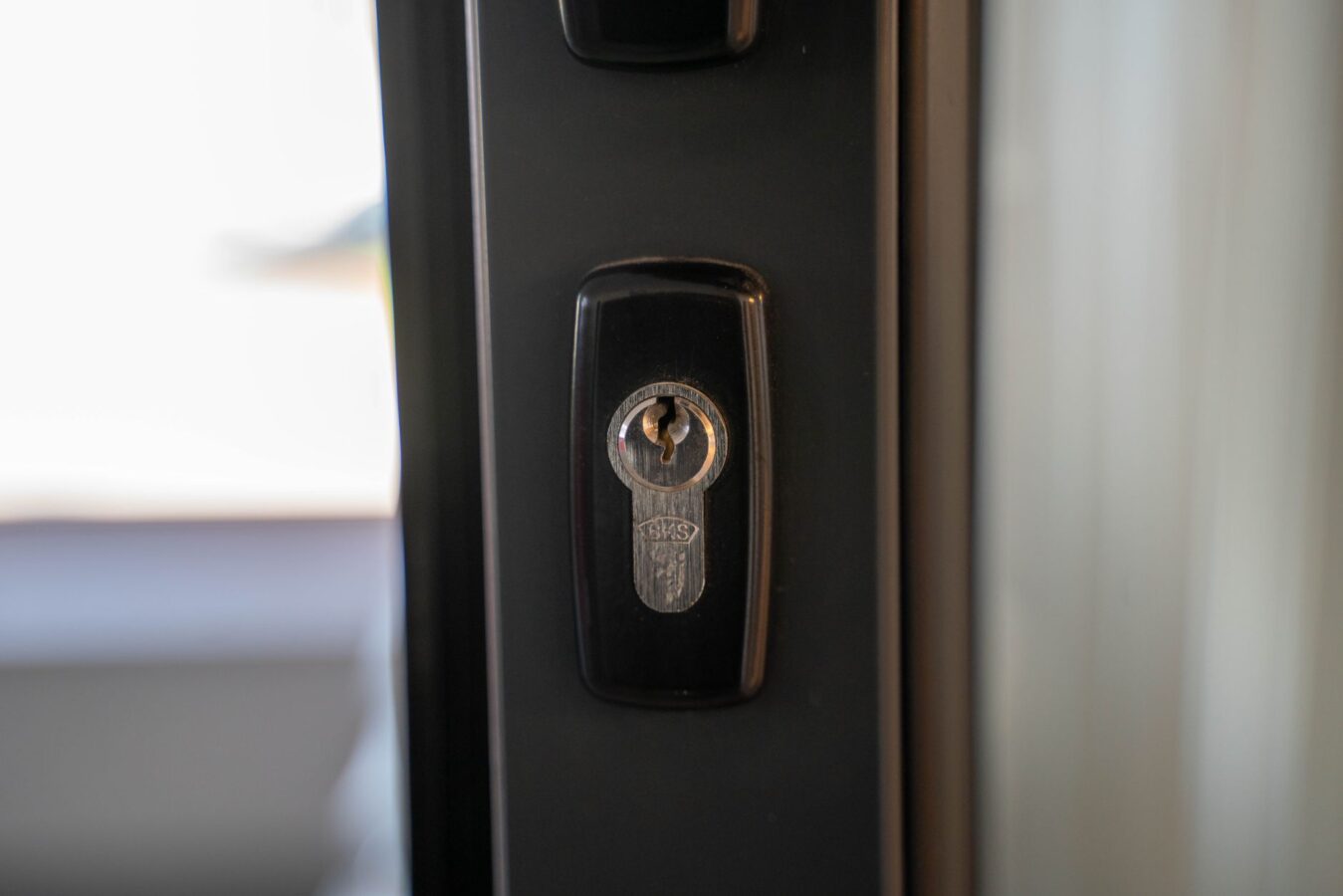 worn car door lock cylinder close-up