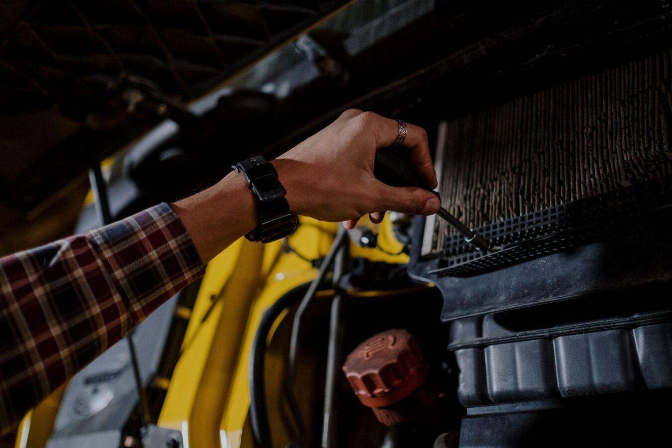 mechanic checking radiator pressure
