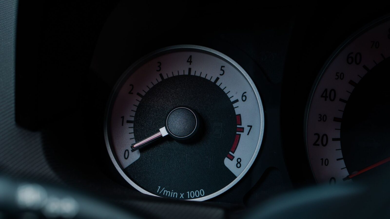 mechanic checking turbocharger shaft play with dial indicator