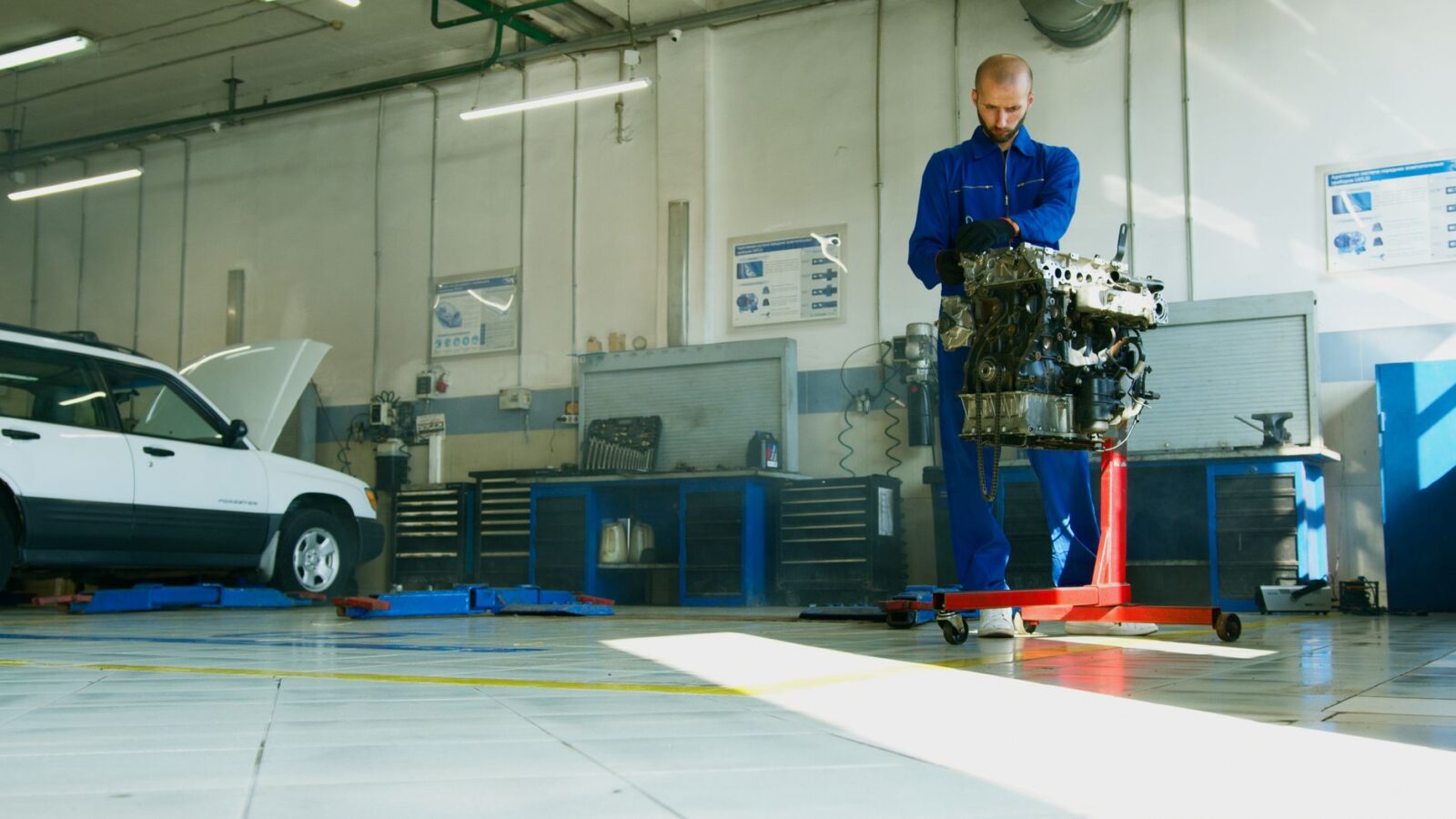 mechanic installing new flywheel on engine block repair garage